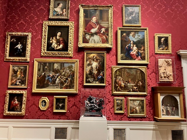 This image shows several renaissance artworks hung salon style