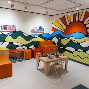 Image of a sunset mural painted on the wall in the Art Park space.