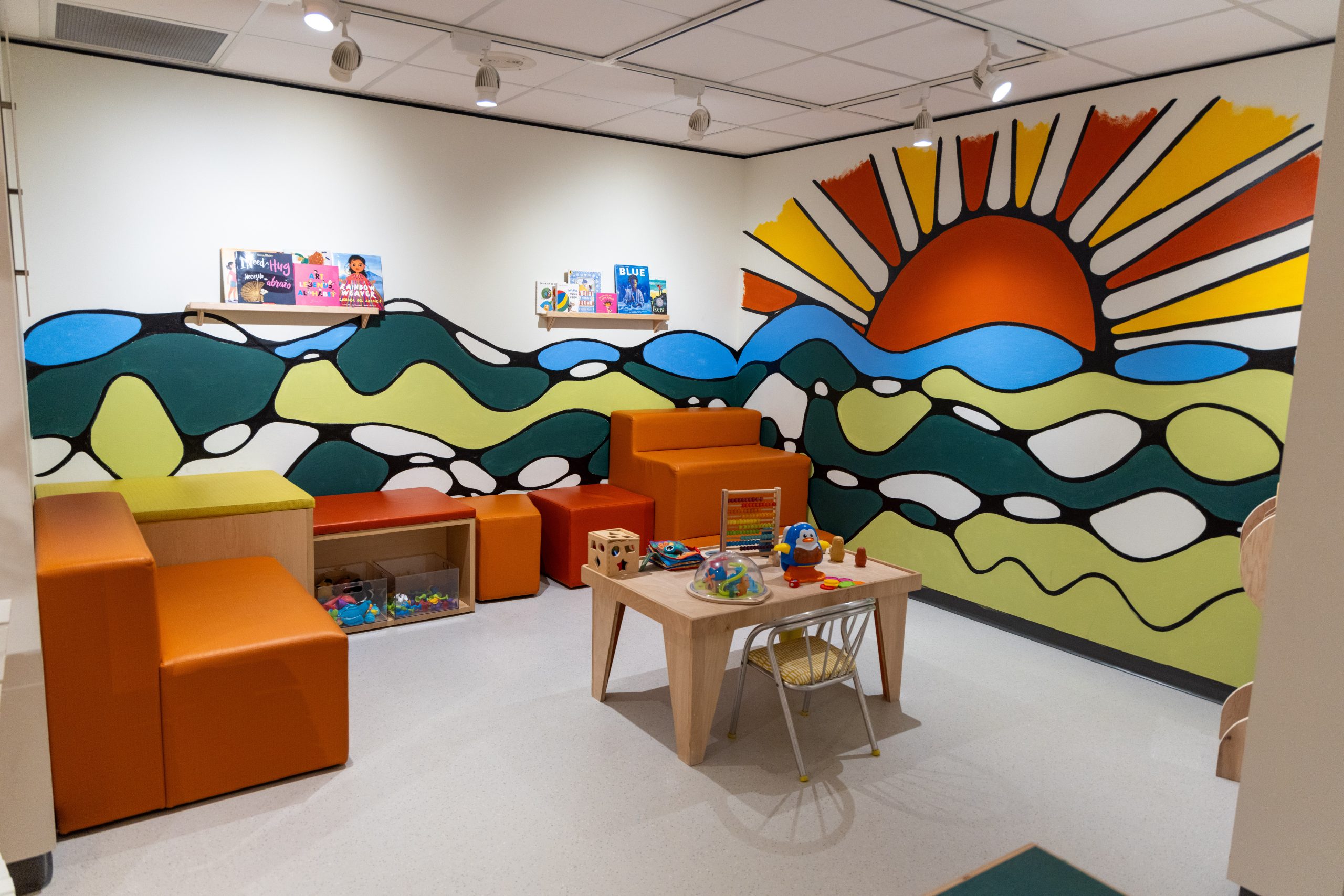 Image of a sunset mural painted on the wall in the Art Park space.