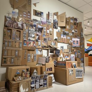 A cardboard cityscape project displayed in Art Park that visitors have contributed to.