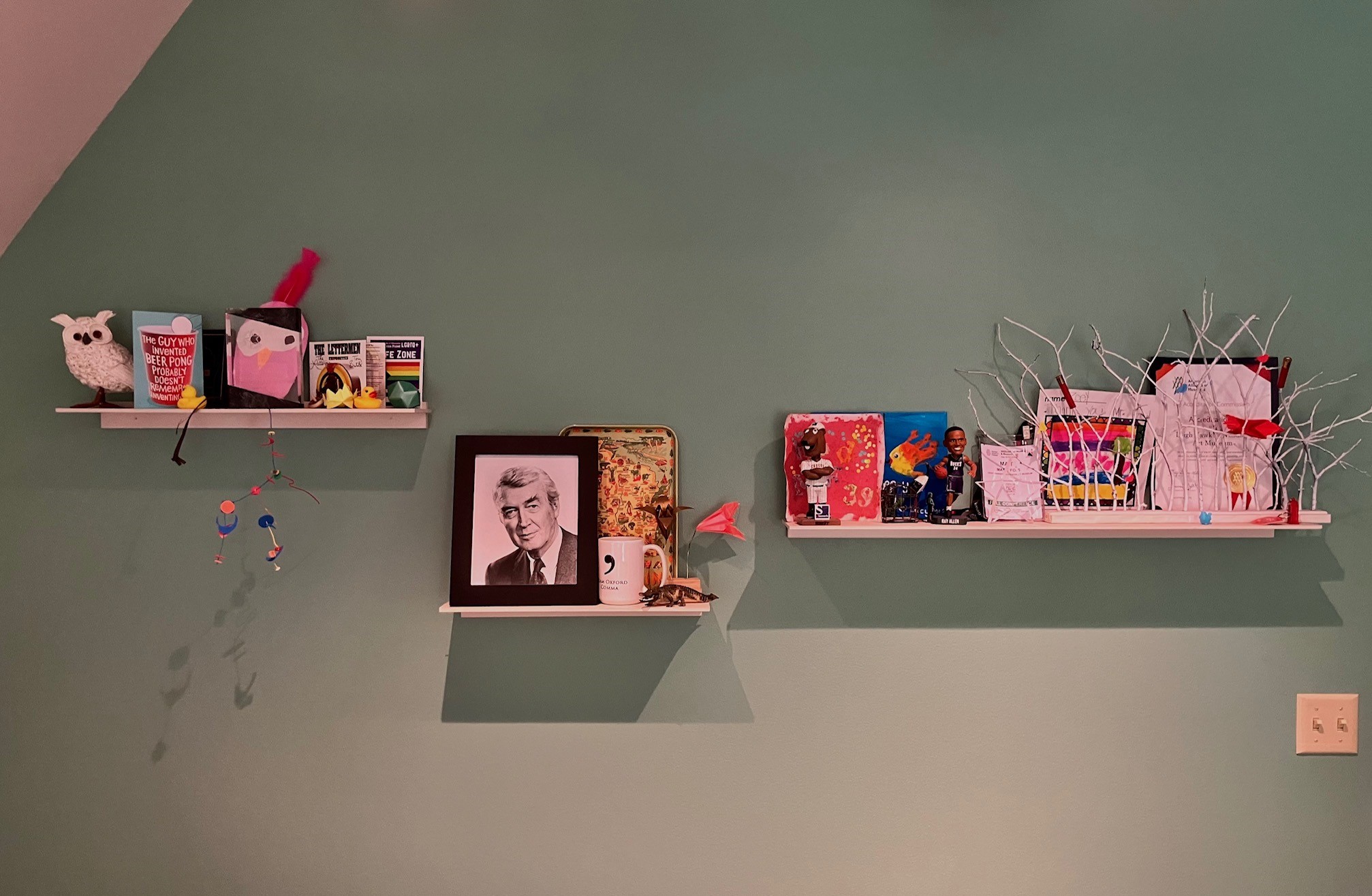 This image shows many items on shelves in an office. Among the items is a black and white photograph of actor Jimmy Stewart