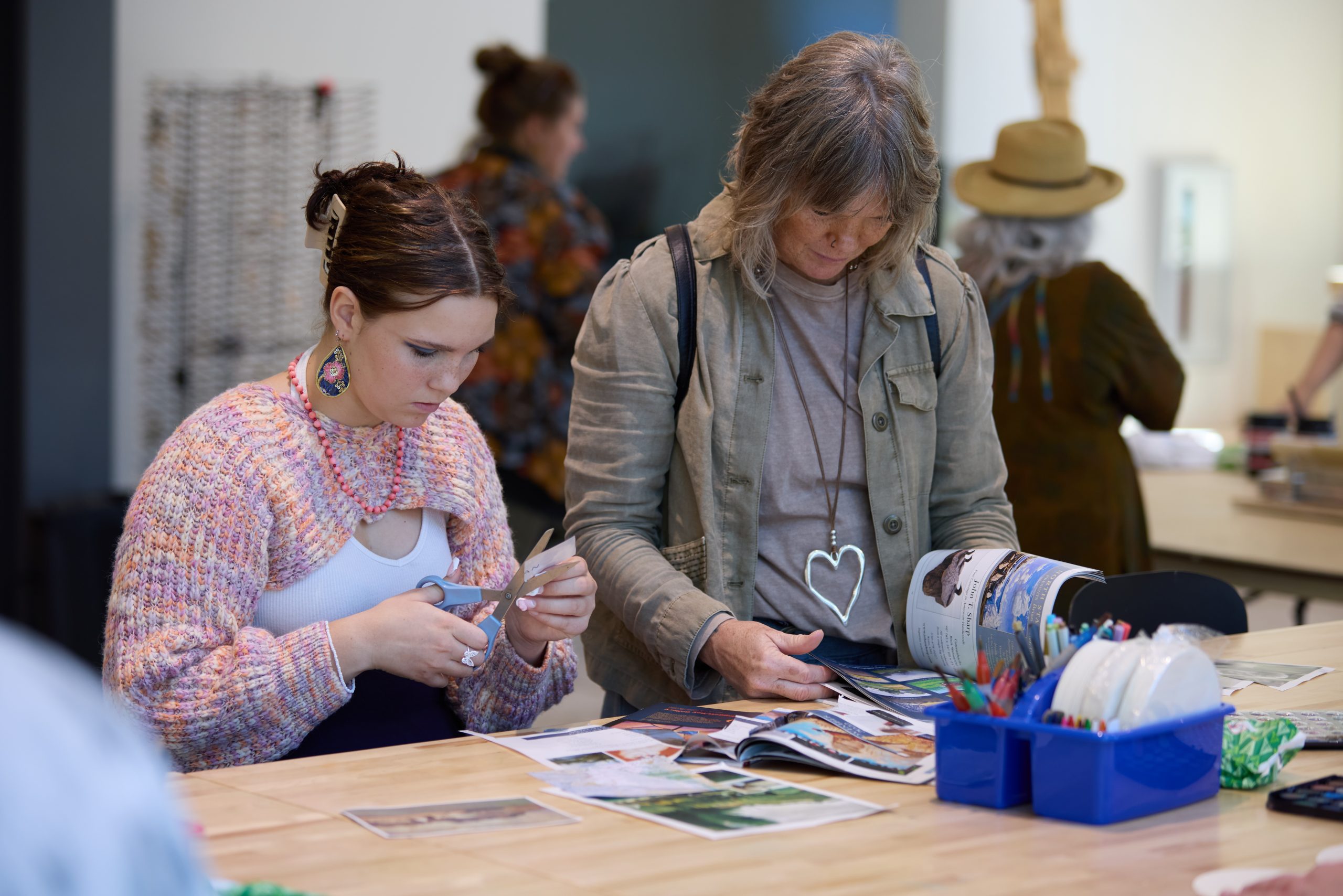 This image shows tow people enjoying making art during a program at the Glass Box Studio