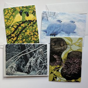 four notecards, one with two yellow birds sitting in a tree with yellow flowers, one is two puffy birds sitting in snow, the next is an owl on a snowy branch, and the last is two otters with sea weed