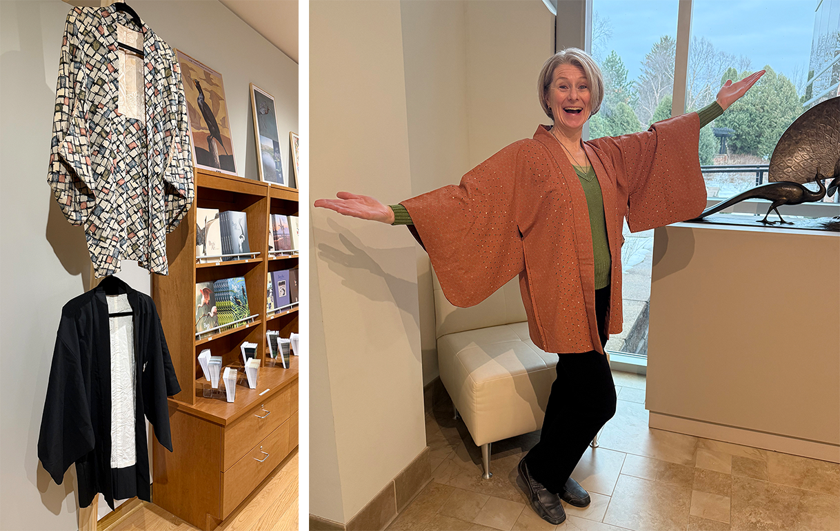 Two kimonos are on display the top colorful and checkered and the bottom in black they are alongside a bookcase